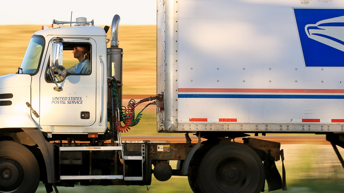 A Postal Service tractor trailer in motion