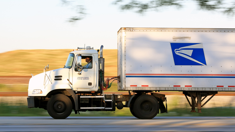 A Postal Service tractor trailer in motion
