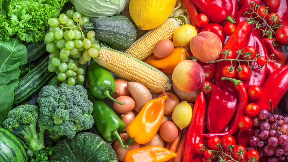 An array of colorful fruits and vegetables on a tabletop