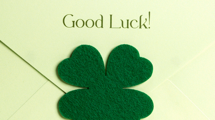 Envelope sealed with a four-leaf clover with the words “Good luck!” written above it