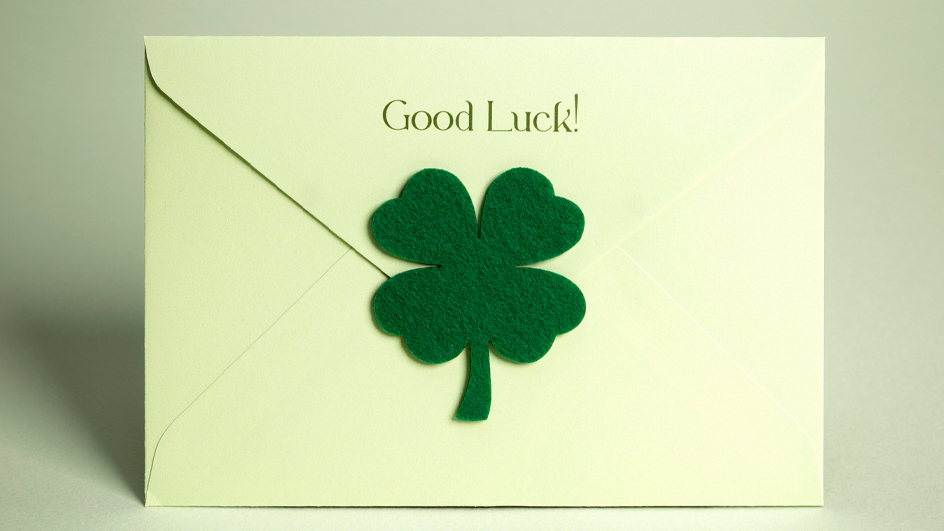 Envelope sealed with a four-leaf clover with the words “Good luck!” written above it