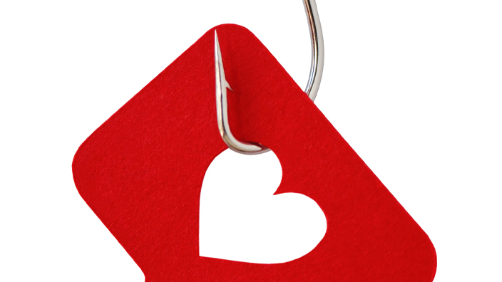 A fishing hook ensnaring a red chat bubble with a heart-shaped hole.