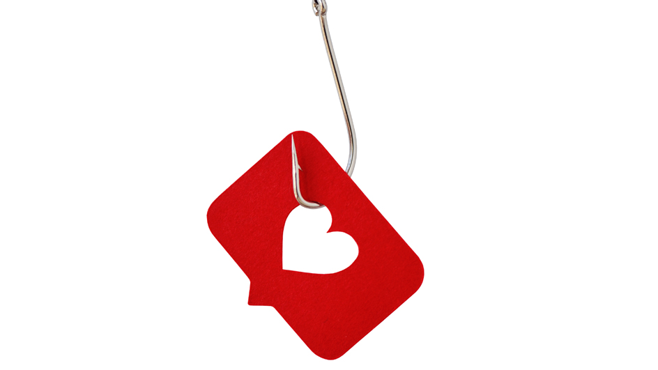 A fishing hook ensnaring a red chat bubble with a heart-shaped hole.