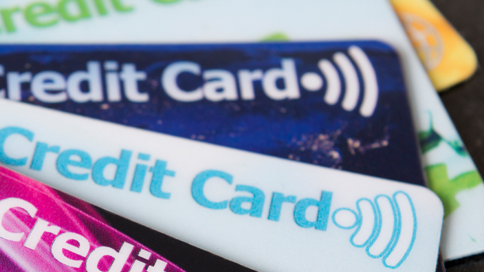 A spread of credit cards on a black background