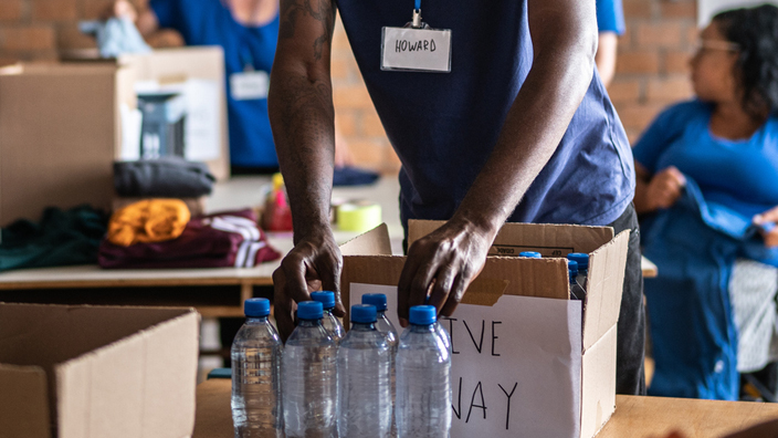 Volunteers arranging donations in a community charity donation center