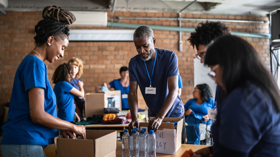 Volunteers arranging donations in a community charity donation center