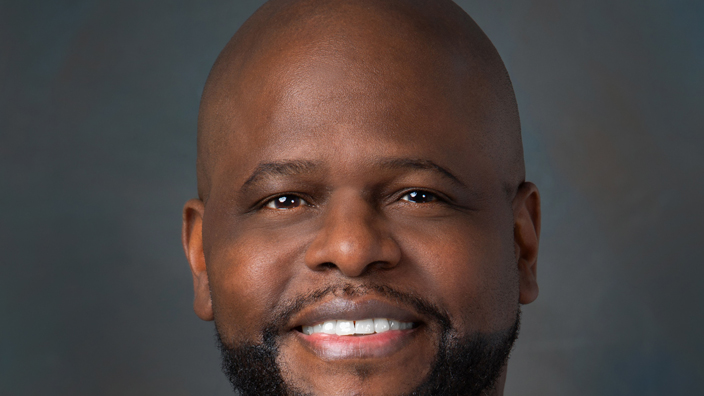 Studio portrait of a smiling man in a business suit and tie