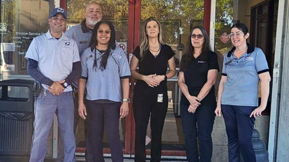 USPS employees standing outside of the Jensen Beach, FL, Post Office