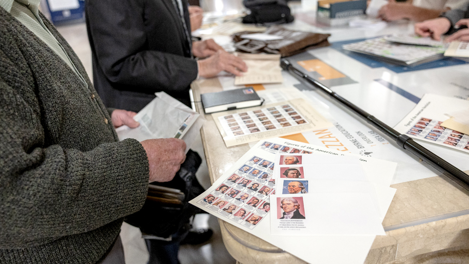 Stamps and stamp-related products for the Figures of the American Revolution stamps sitting on a table