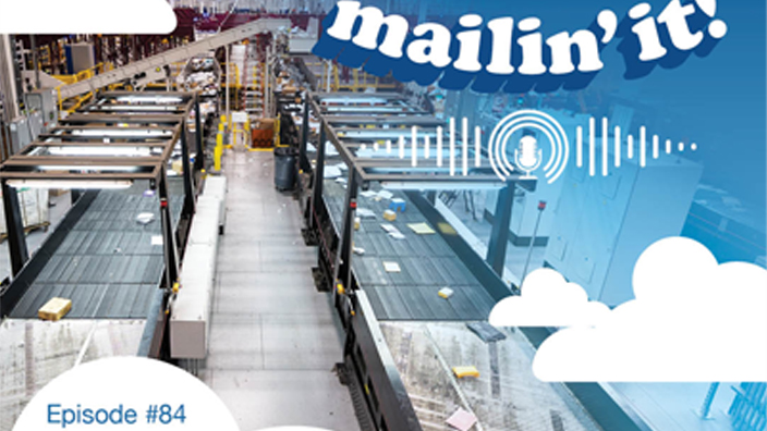 The logo for the USPS podcast displaying the words “Mailin’ It” and an image of a woman and a brick building.