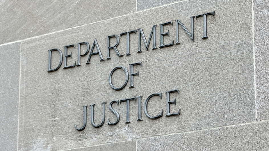 Letters spelling out “Department of Justice” affixed to the side of a building
