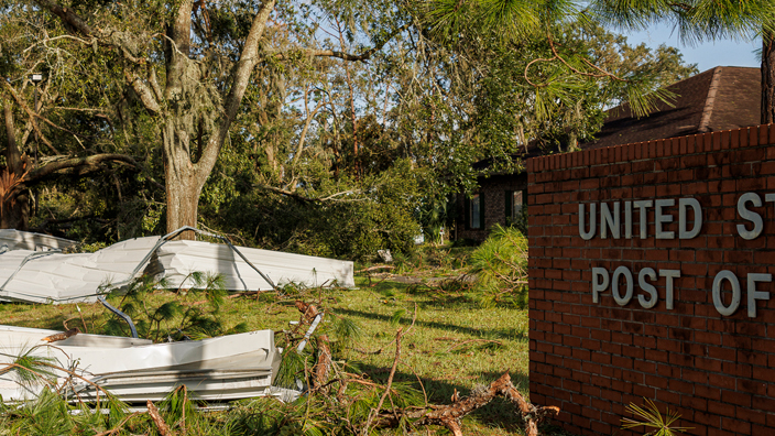 The exterior of Post Office showing damage from a storm.