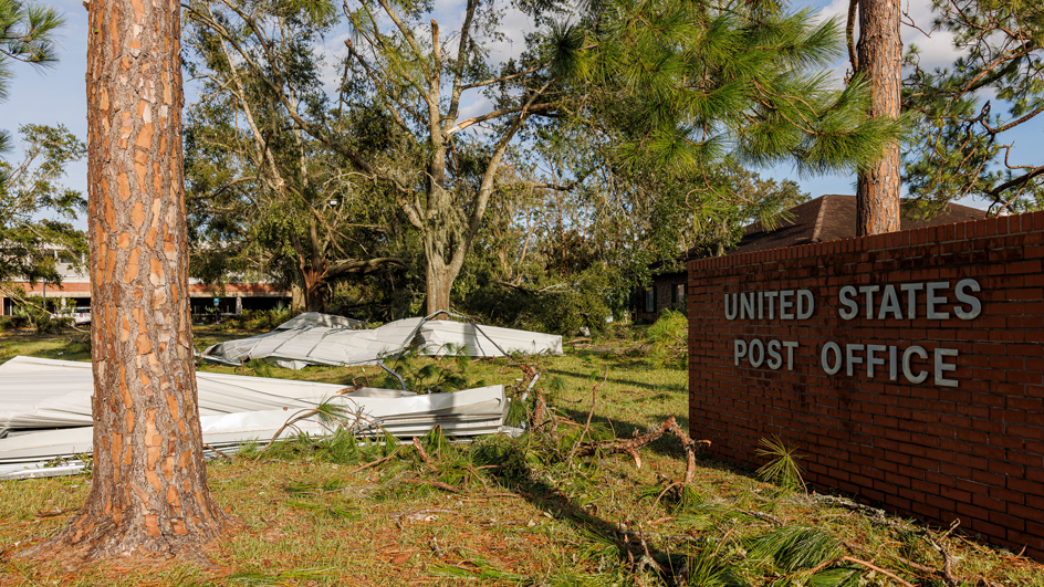 The exterior of Post Office showing damage from a storm.