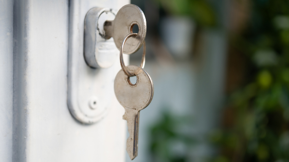 Keys dangling in the lock to a door