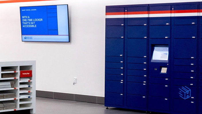 A bank of blue package lockers inside a Post Office lobby.