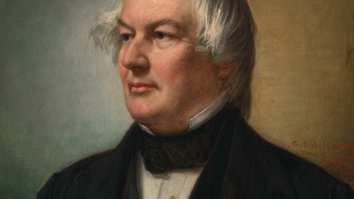 Left-facing color portrait of President Millard Fillmore wearing a dark suit and white shirt