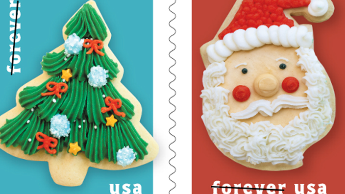 Four stamps with images of cookies in the shapes of a Christmas tree, Santa Claus, a wrapped present and a stocking