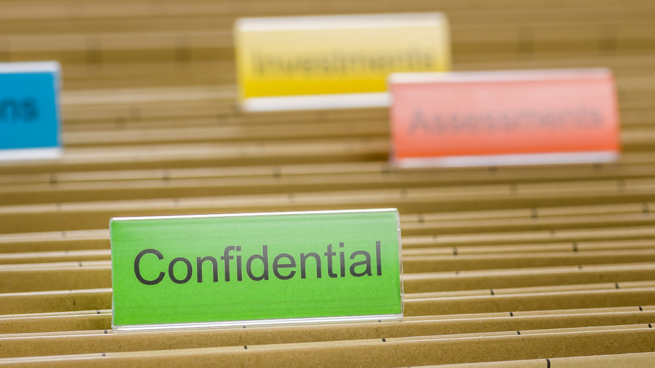 Brown hanging file folder with a green tab labeled “confidential”