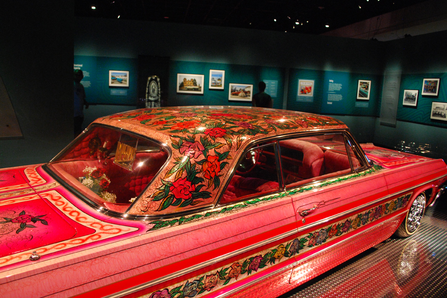 A pink 1964 Chevrolet Impala with painted-on roses