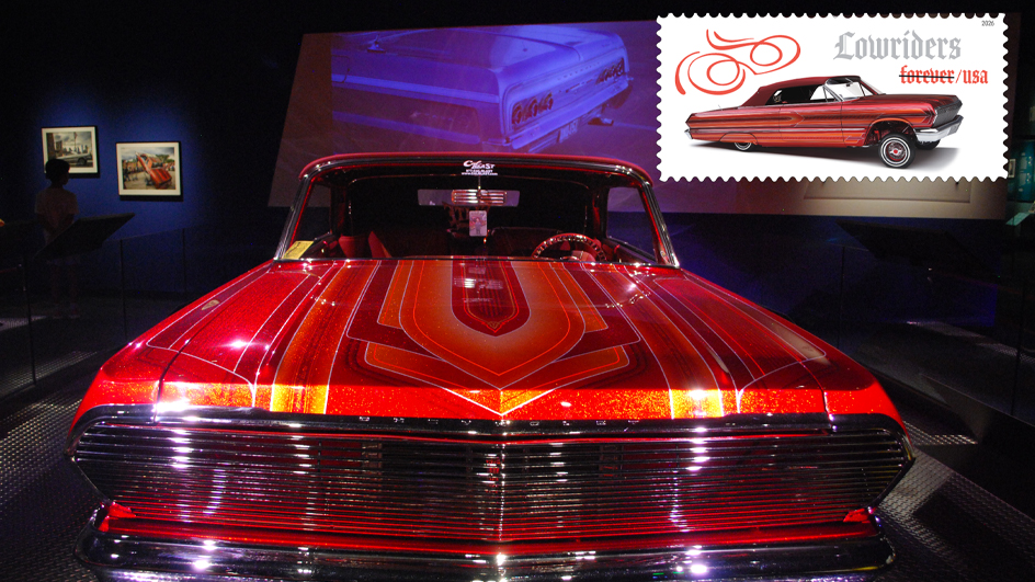 A red 1963 Chevrolet Impala in a dark room with a spotlight shining on it