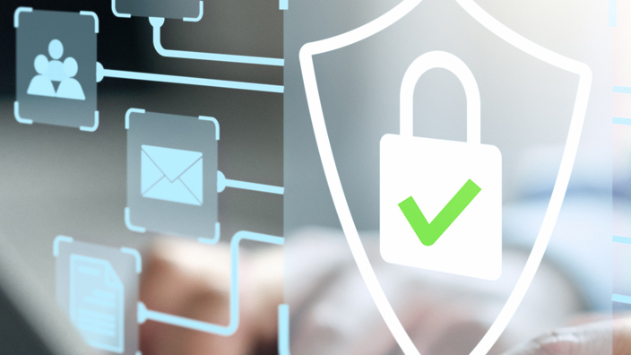 Man typing on a laptop with cybersecurity alert images