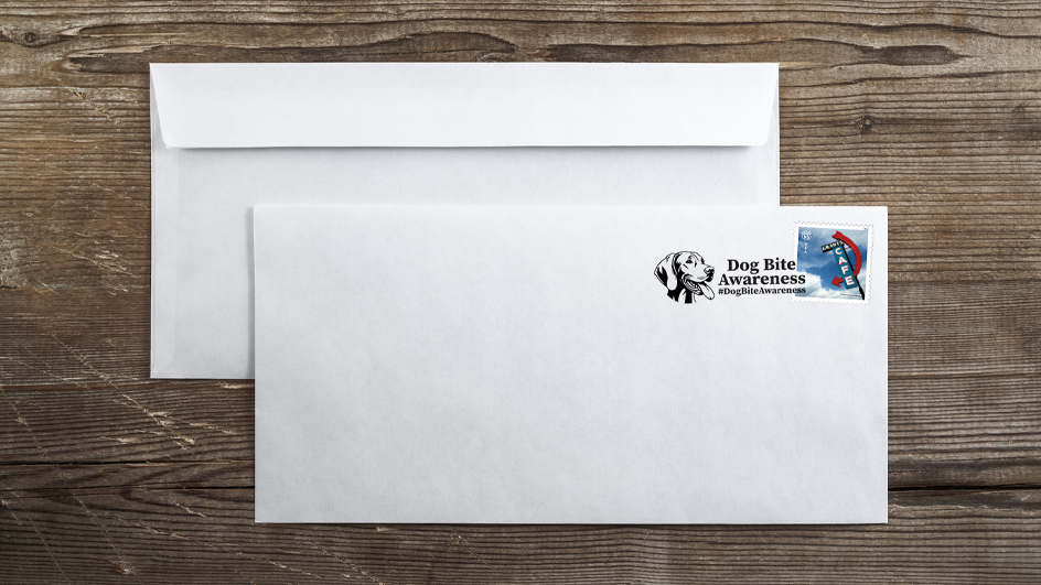 An envelope with a postmark featuring the image of a dog’s head reading “Dog Bite Awareness”