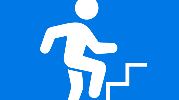 An illustration of a person walking upstairs, symbolizing the climb up a career ladder