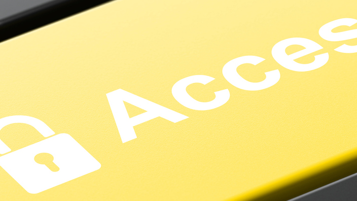 Computer keyboard with a yellow button labeled “Access” with a padlock icon