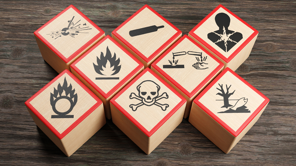 Eight wooden blocks showing globally recognized hazardous material symbols