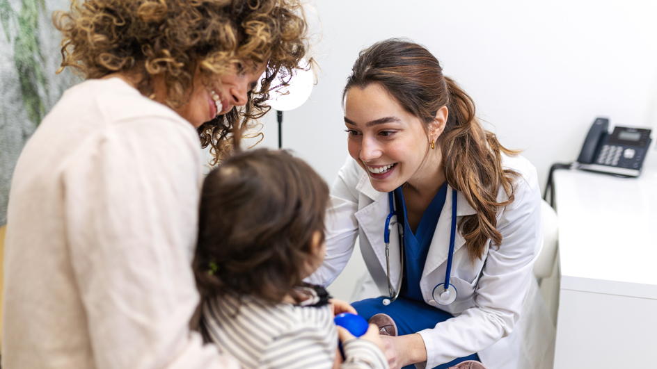 Doctor using a stethoscope to check a baby’s heartbeat